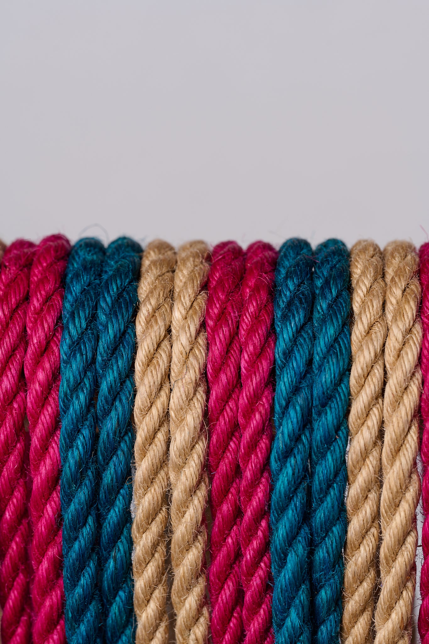 Close-up of multicolored ropes on a light gray background